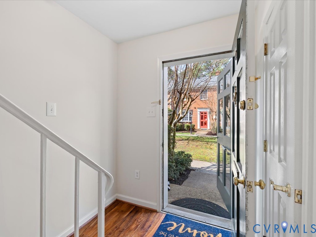 9107 Derbyshire Road, Unit J Henrico, VA 23229 - Photo 7 of 38 a view of a balcony with wooden floor and door