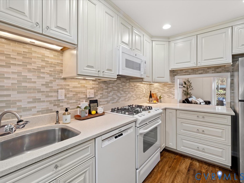 9107 Derbyshire Road, Unit J Henrico, VA 23229 - Photo 10 of 38 a kitchen with white cabinets stainless steel appliances and sink
