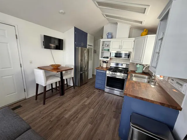 a kitchen with stainless steel appliances and wooden cabinets