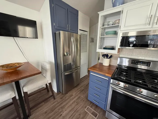 a kitchen with stainless steel appliances granite countertop a stove and a sink