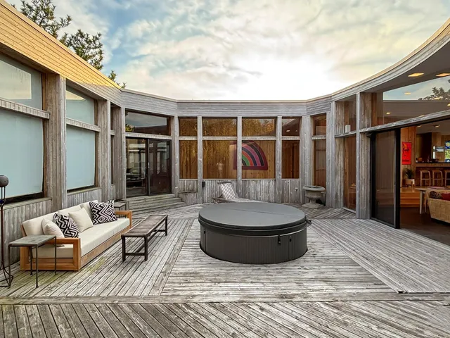 a living room with furniture a rug and white walls