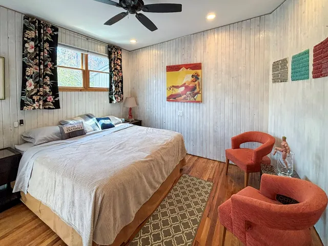 a bedroom with stainless steel bed and window