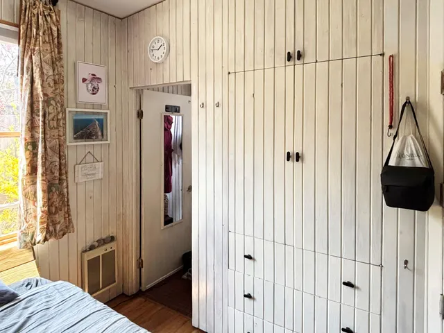 a view of a bedroom with a bed and a window