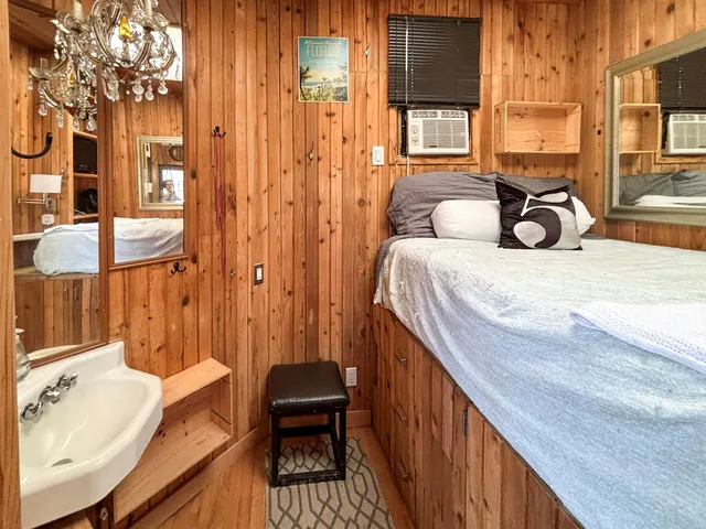 a spacious bedroom with a bed and a table in it