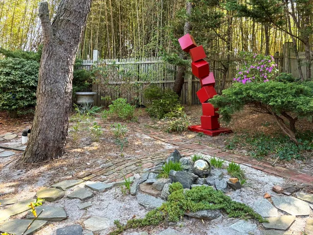 a backyard of a house with lots of green space and fountain