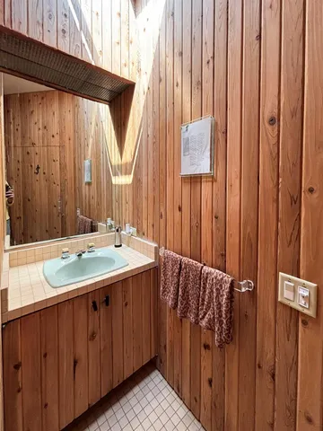 a bathroom with a double vanity sink and a mirror