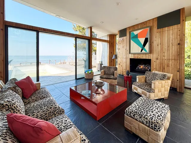 a living room with furniture a rug and a large window