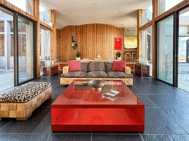 a living room with a couch and a table with wooden floor