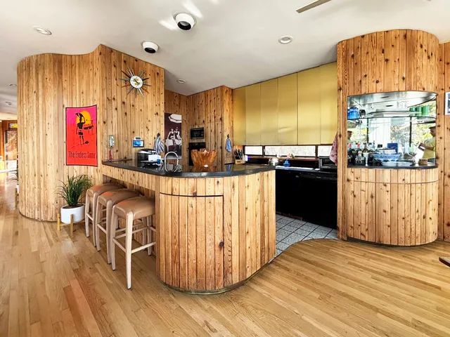 a kitchen with stainless steel appliances granite countertop a sink dishwasher and a stove with wooden floor