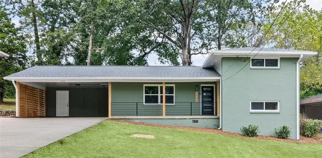 a front view of a house with a garden