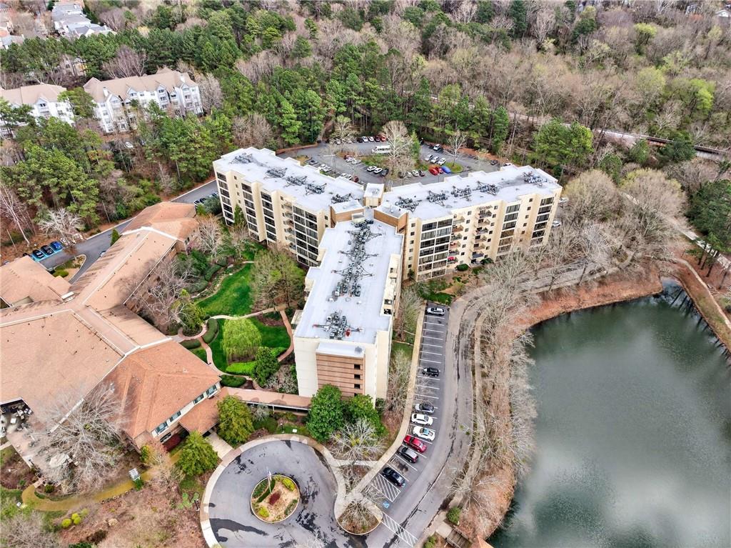 an aerial view of a house with a yard lake and outdoor seating