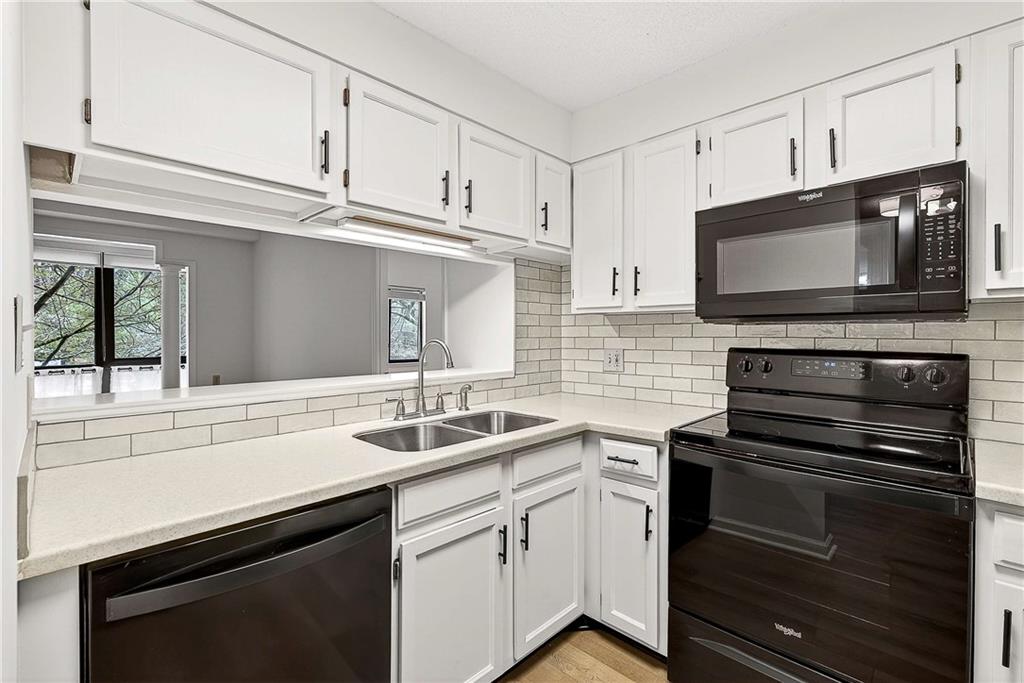 1800 Clairmont Lake, Unit A227 Decatur, GA 30033 - Photo 13 of 69 a kitchen with granite countertop a sink stainless steel appliances and cabinets
