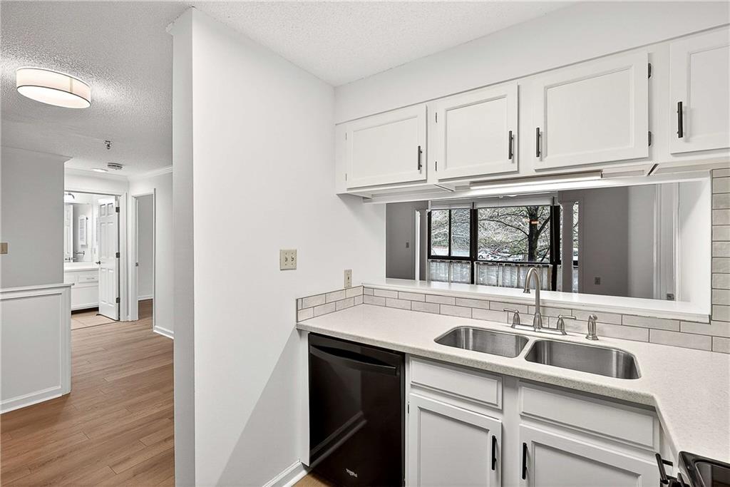 1800 Clairmont Lake, Unit A227 Decatur, GA 30033 - Photo 14 of 69 a kitchen with stainless steel appliances granite countertop a sink and dishwasher with wooden floor