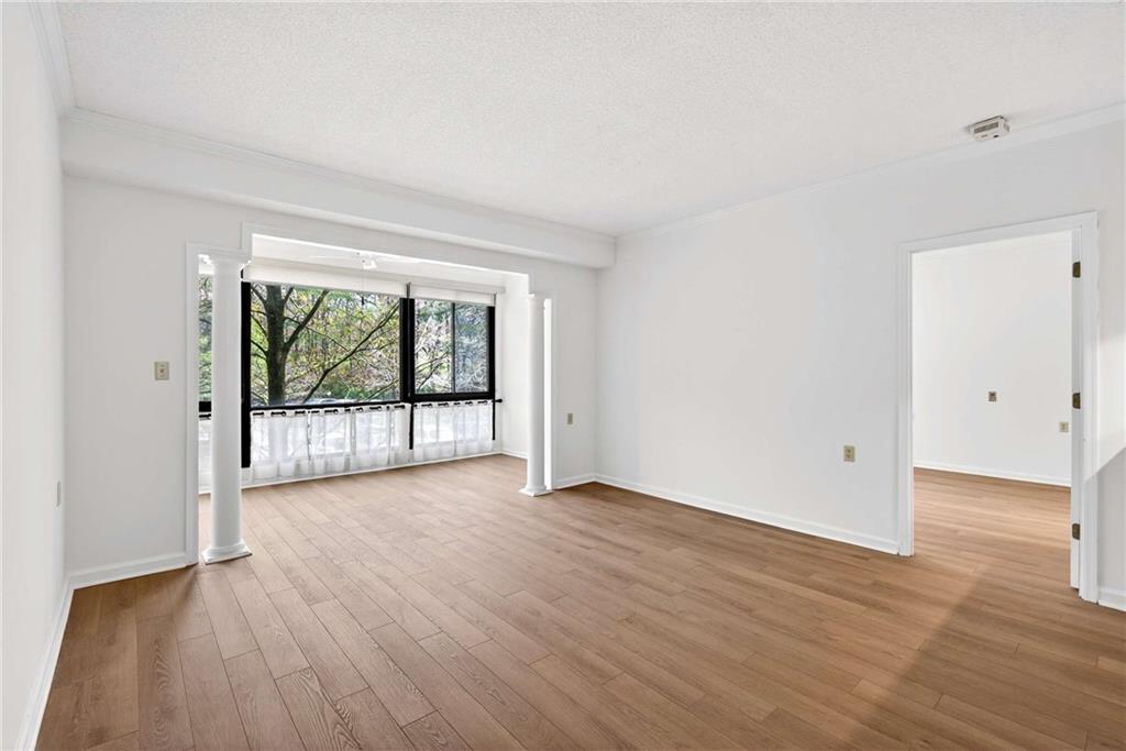 1800 Clairmont Lake, Unit A227 Decatur, GA 30033 - Photo 17 of 69 a view of an empty room with wooden floor and a window