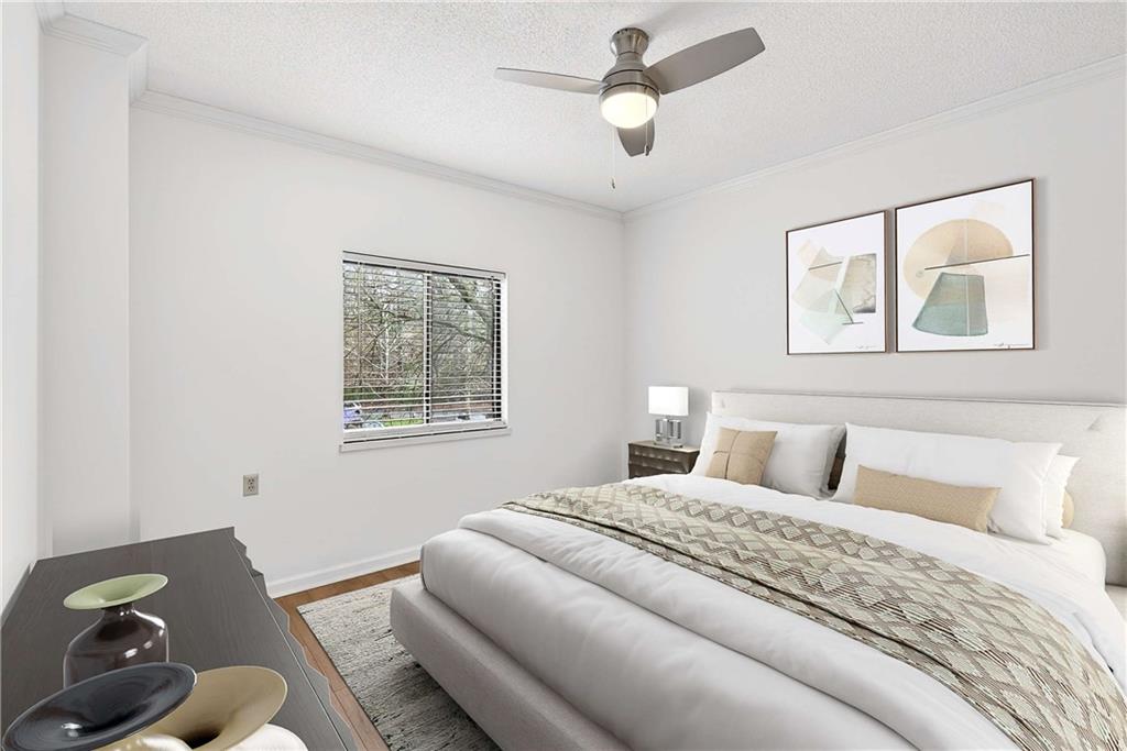 1800 Clairmont Lake, Unit A227 Decatur, GA 30033 - Photo 26 of 69 a bedroom with a bed and wooden floor