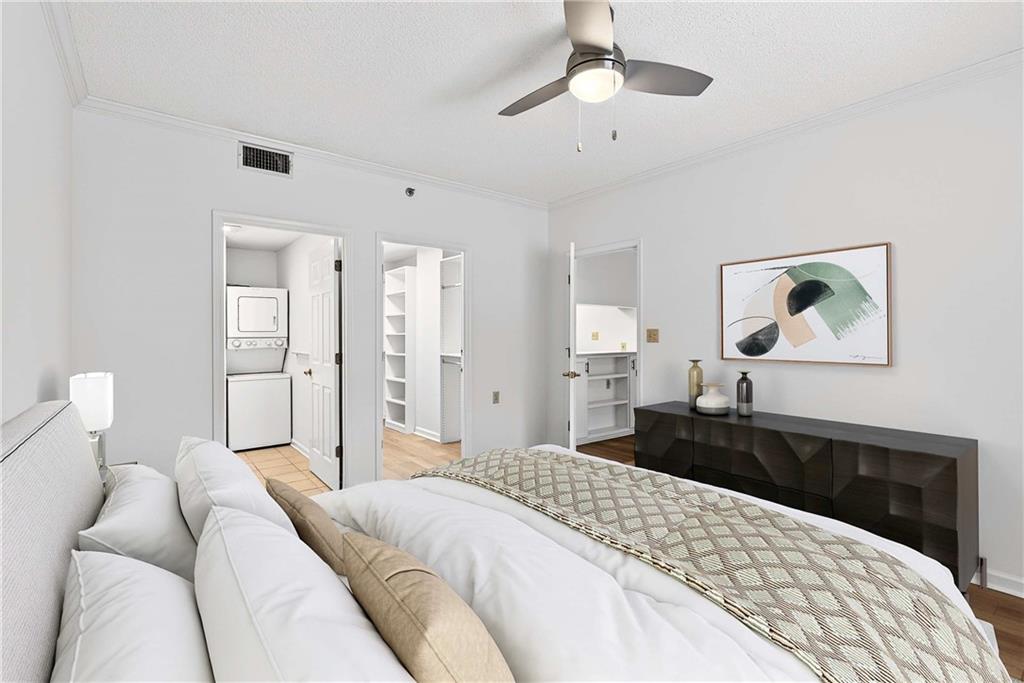 1800 Clairmont Lake, Unit A227 Decatur, GA 30033 - Photo 28 of 69 a bedroom with a bed and a chandelier