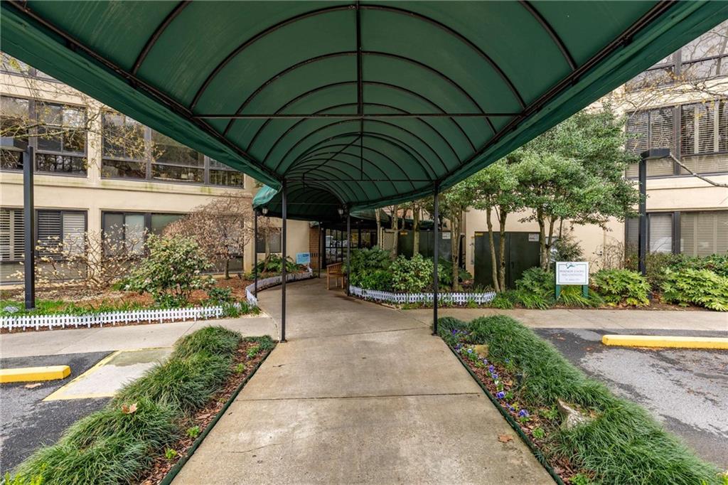 1800 Clairmont Lake, Unit A227 Decatur, GA 30033 - Photo 3 of 69 a patio with a table and chairs under an umbrella