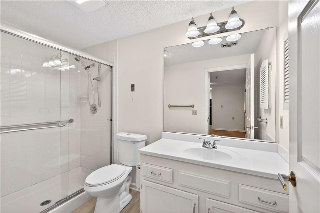 1800 Clairmont Lake, Unit A227 Decatur, GA 30033 - Photo 38 of 69 a bathroom with a sink a toilet and shower