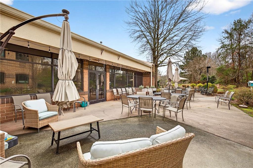 1800 Clairmont Lake, Unit A227 Decatur, GA 30033 - Photo 48 of 69 a view of a patio with dining table and chairs