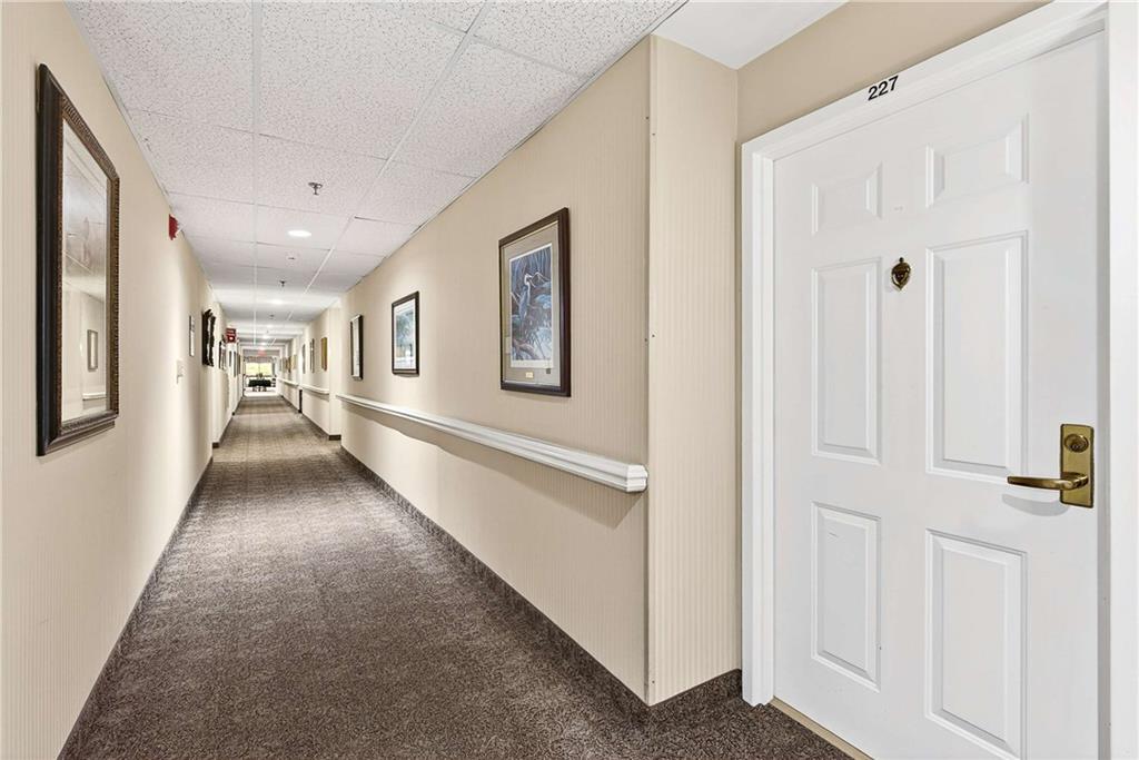 1800 Clairmont Lake, Unit A227 Decatur, GA 30033 - Photo 5 of 69 a view of a hallway with wooden floor and windows