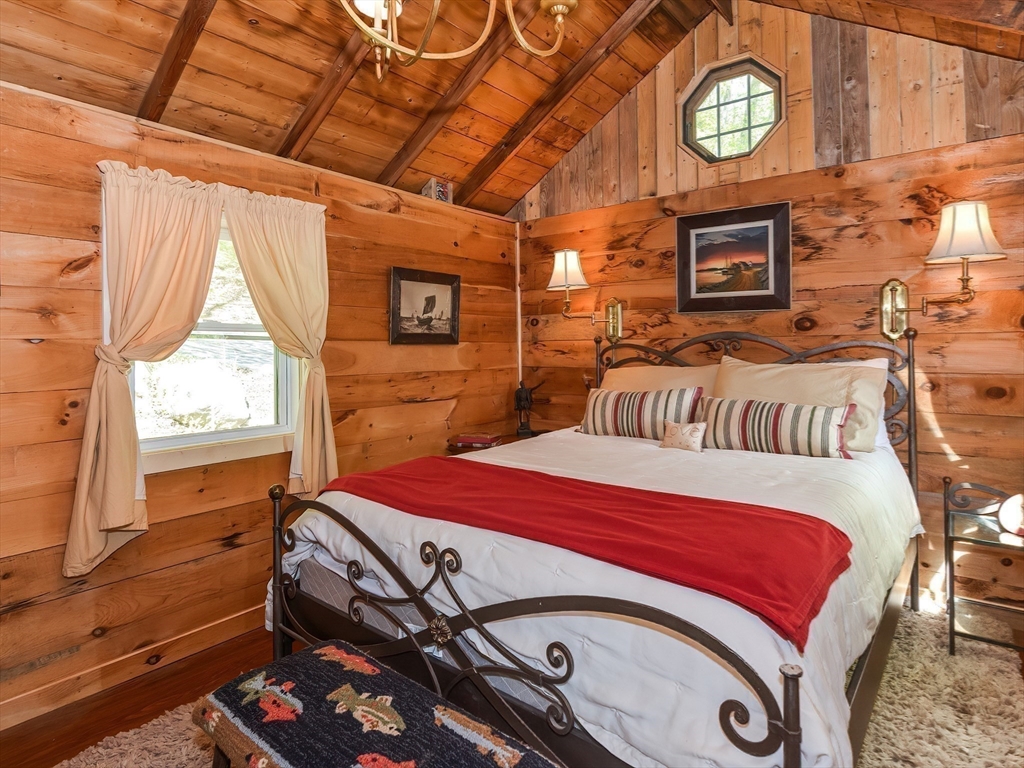 38 Cote Lane Sutton, MA 01590 - Photo 16 of 33 a bedroom with a bed a fireplace and a window
