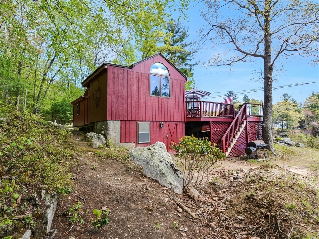 38 Cote Lane Sutton, MA 01590 - Photo 25 of 33 a view of a house with a yard and wooden fence