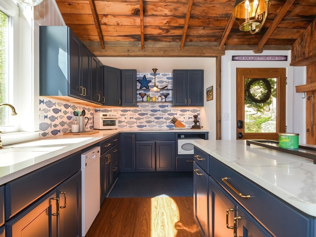 38 Cote Lane Sutton, MA 01590 - Photo 8 of 33 a kitchen with a sink stove and cabinets