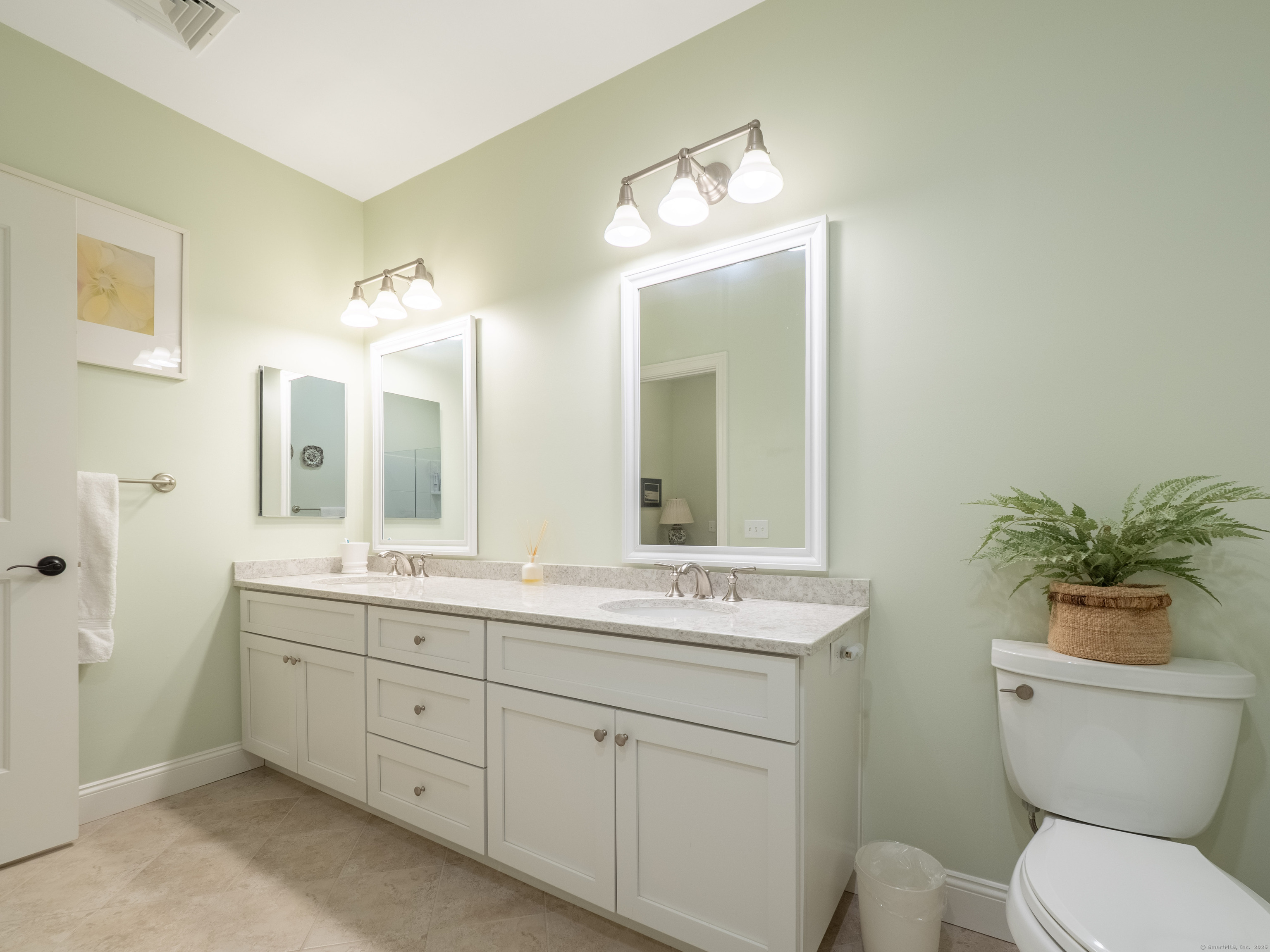 77 Sunset Lane, Unit 223 Ridgefield, CT 06877 - Photo 18 of 38 a bathroom with a toilet a sink and a large mirror
