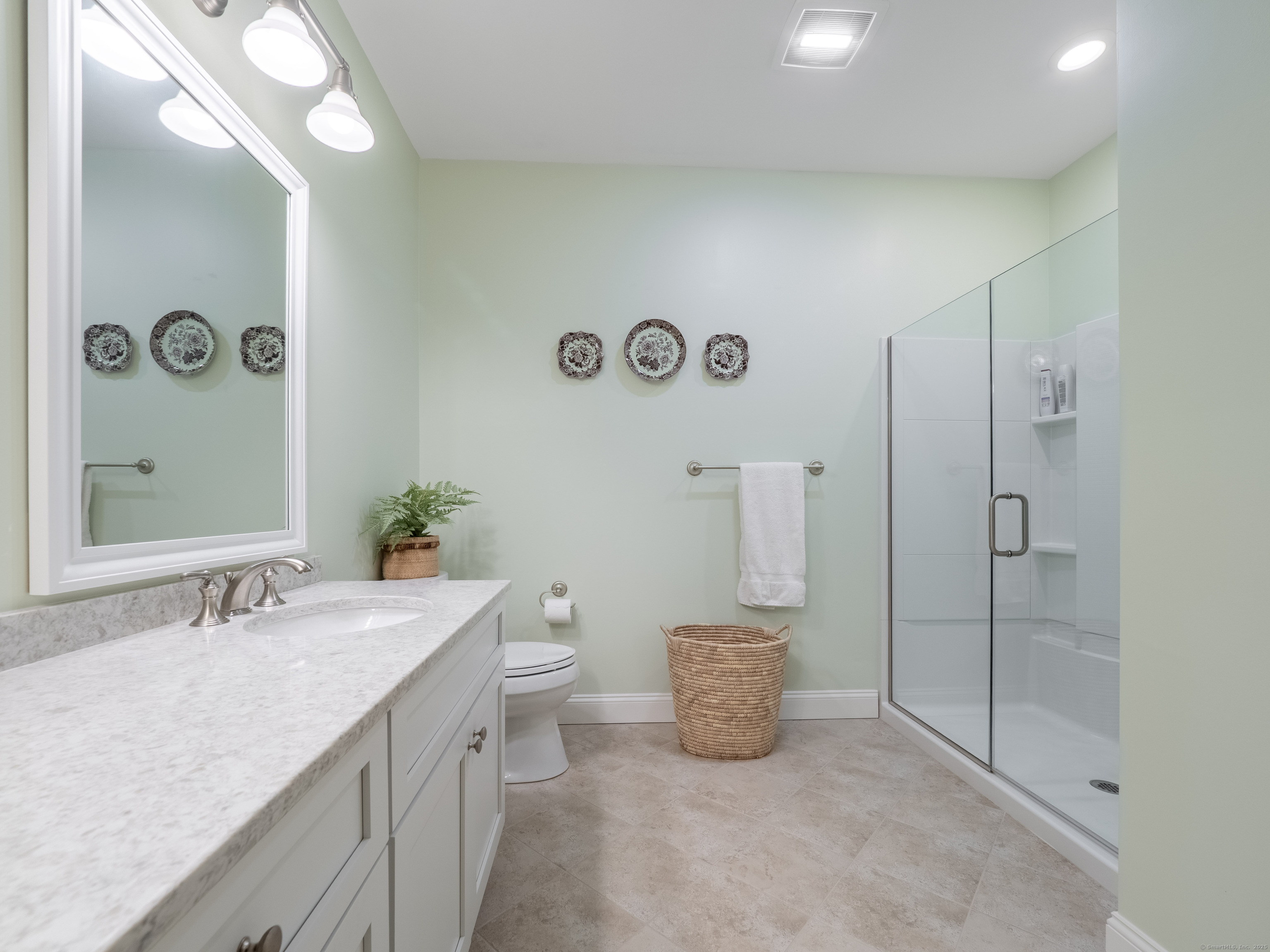 77 Sunset Lane, Unit 223 Ridgefield, CT 06877 - Photo 19 of 38 a bathroom with a double vanity sink mirror and toilet