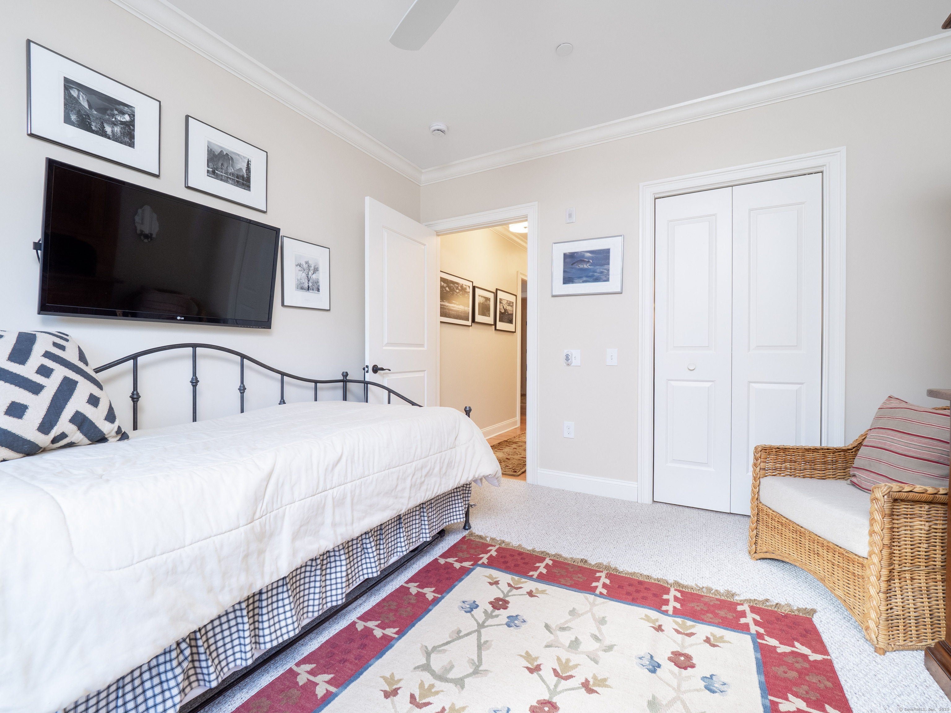 77 Sunset Lane, Unit 223 Ridgefield, CT 06877 - Photo 21 of 38 a bedroom with a bed and a flat screen tv