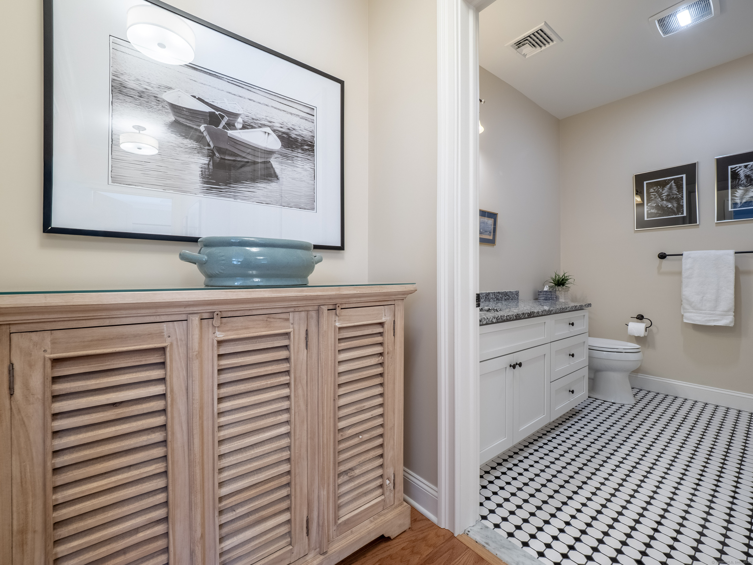 77 Sunset Lane, Unit 223 Ridgefield, CT 06877 - Photo 24 of 38 a bathroom with a granite countertop toilet a sink and a mirror
