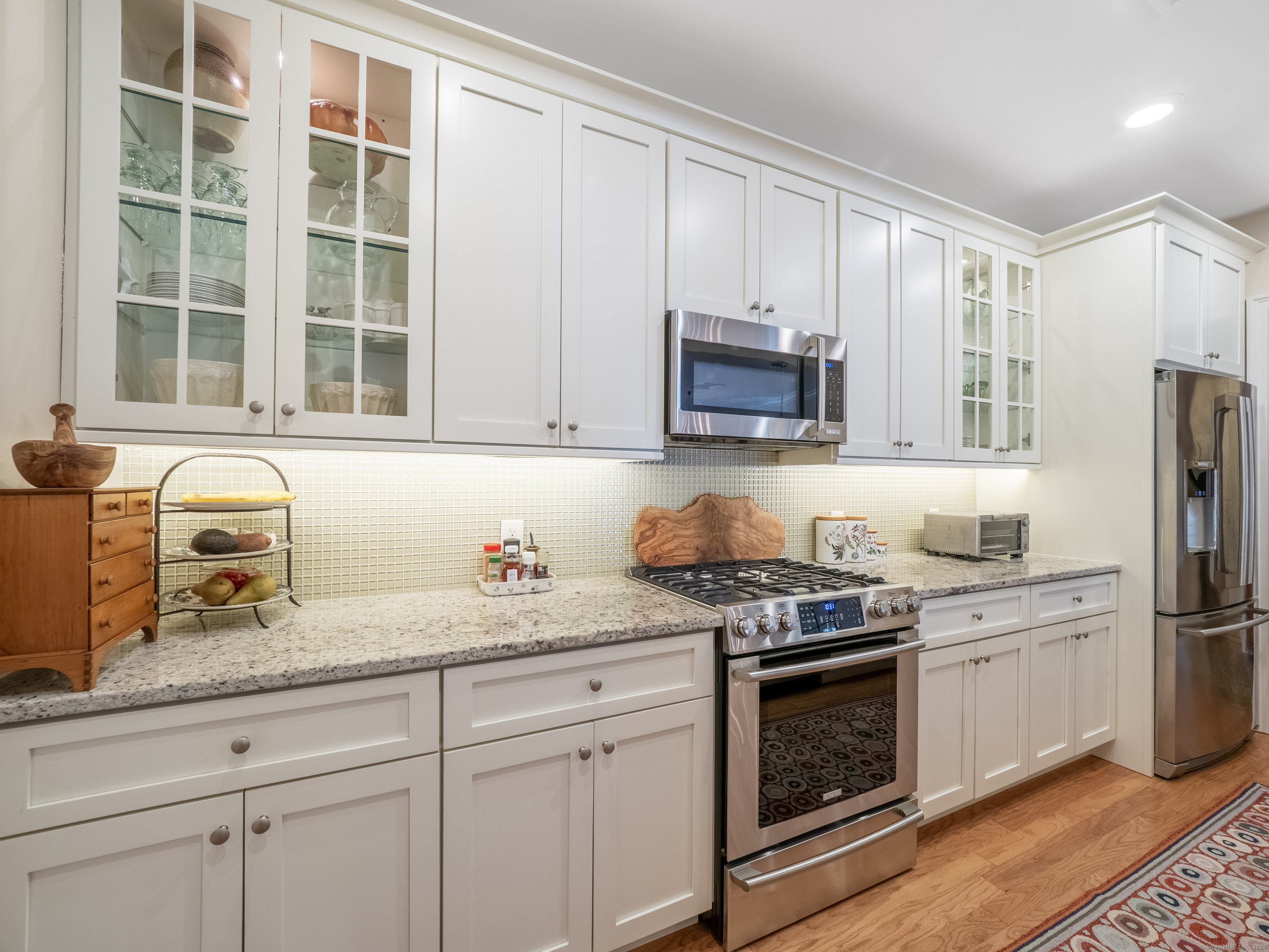 77 Sunset Lane, Unit 223 Ridgefield, CT 06877 - Photo 7 of 38 a kitchen with appliances a sink and cabinets