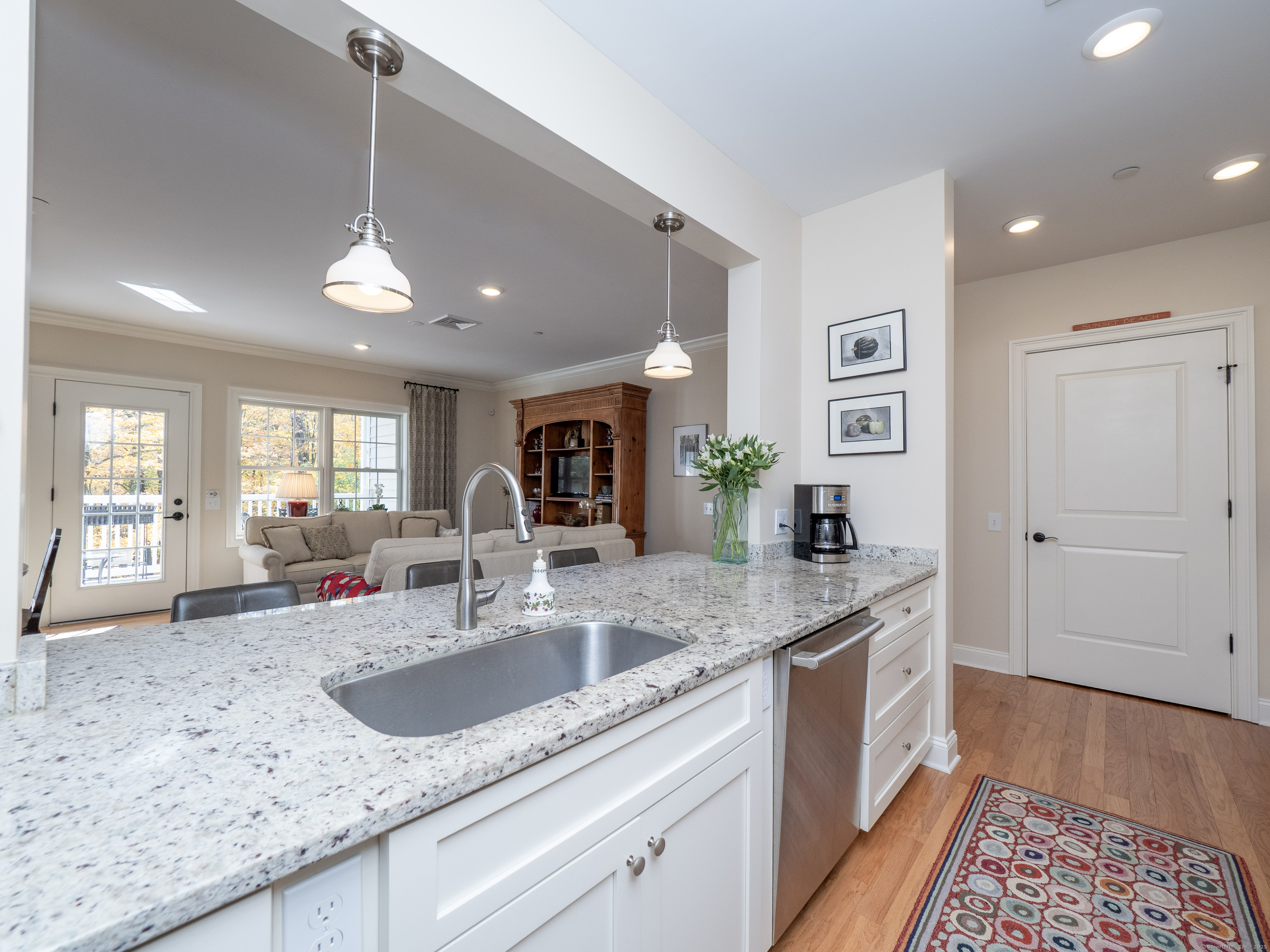 77 Sunset Lane, Unit 223 Ridgefield, CT 06877 - Photo 9 of 38 a kitchen with stainless steel appliances granite countertop a sink a counter space and cabinets