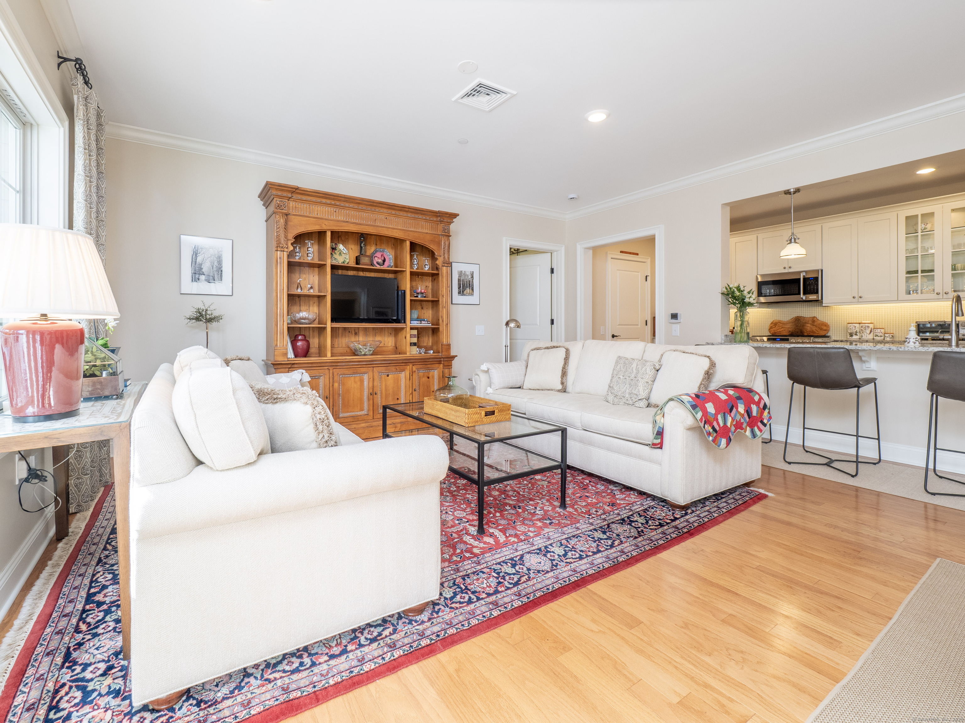 77 Sunset Lane, Unit 223 Ridgefield, CT 06877 - Photo 10 of 38 a living room with furniture and a flat screen tv