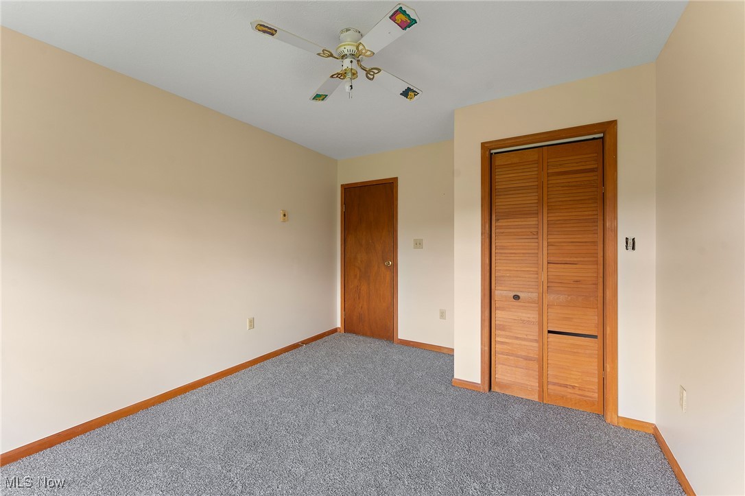 5511 Monroe Center Road Conneaut, OH 44030 - Photo 23 of 39 Bedroom featuring a closet, carpet, and ceiling fan