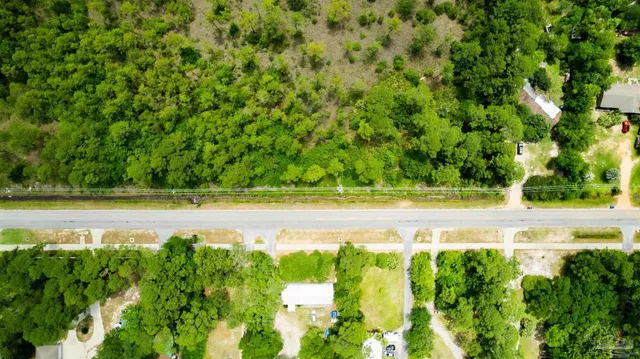 a view of yard with swimming pool and green space