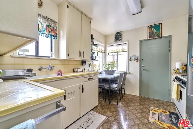 a bathroom with a sink a toilet and shower curtain
