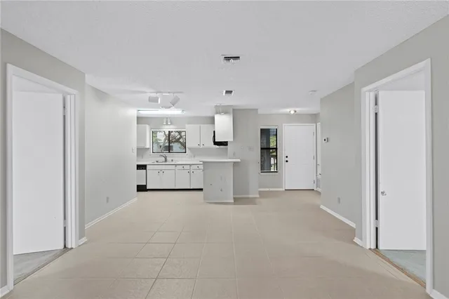 a kitchen with a sink cabinets and stainless steel appliances