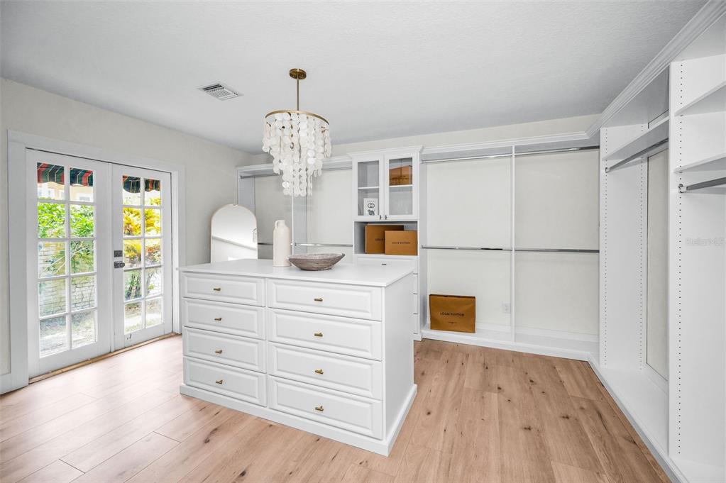 409 Barbara Lane Tampa, FL 33609 - Photo 12 of 51 a view of a hallway with wooden floor and chandelier