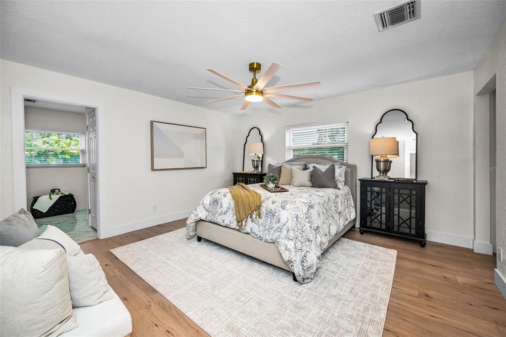 409 Barbara Lane Tampa, FL 33609 - Photo 15 of 51 a bedroom with a bed and a chandelier