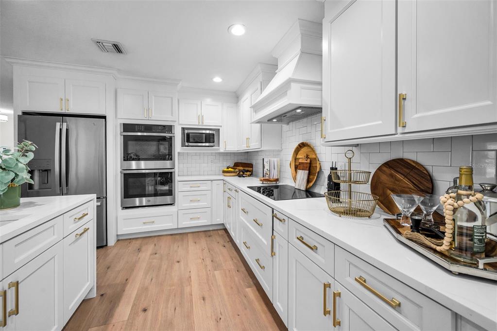 409 Barbara Lane Tampa, FL 33609 - Photo 26 of 51 a kitchen with stainless steel appliances a stove sink and cabinets