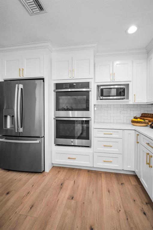 409 Barbara Lane Tampa, FL 33609 - Photo 27 of 51 a kitchen with stainless steel appliances kitchen island granite countertop a refrigerator microwave and sink