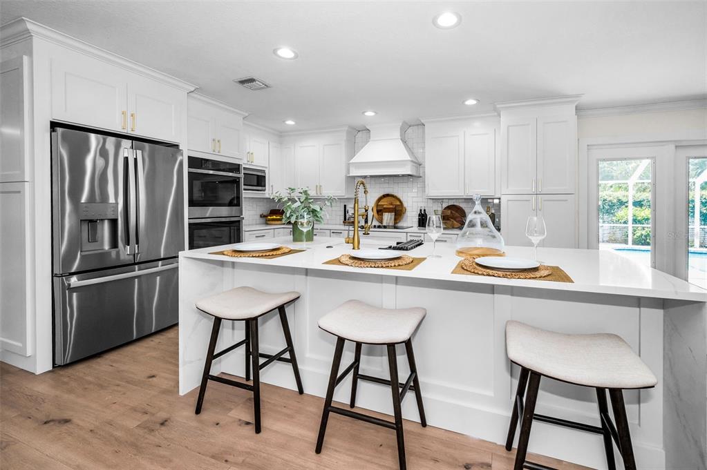 409 Barbara Lane Tampa, FL 33609 - Photo 28 of 51 a kitchen with a sink cabinets and stainless steel appliances