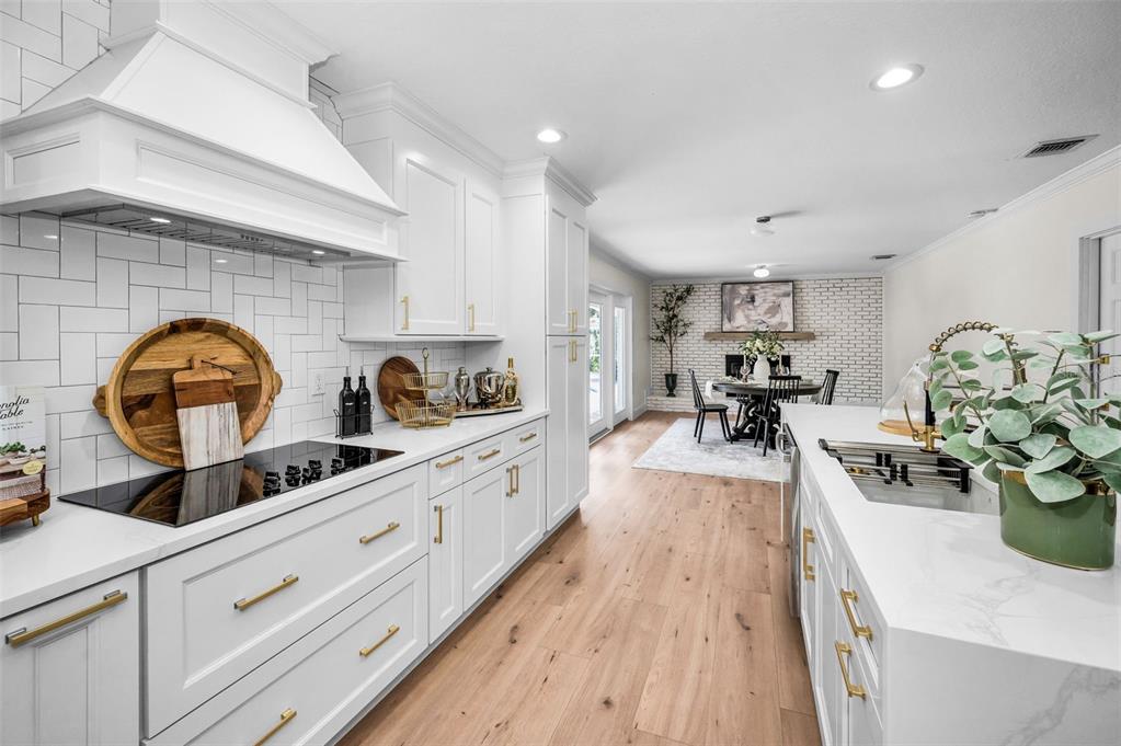 409 Barbara Lane Tampa, FL 33609 - Photo 31 of 51 a kitchen with sink stove top oven and cabinets