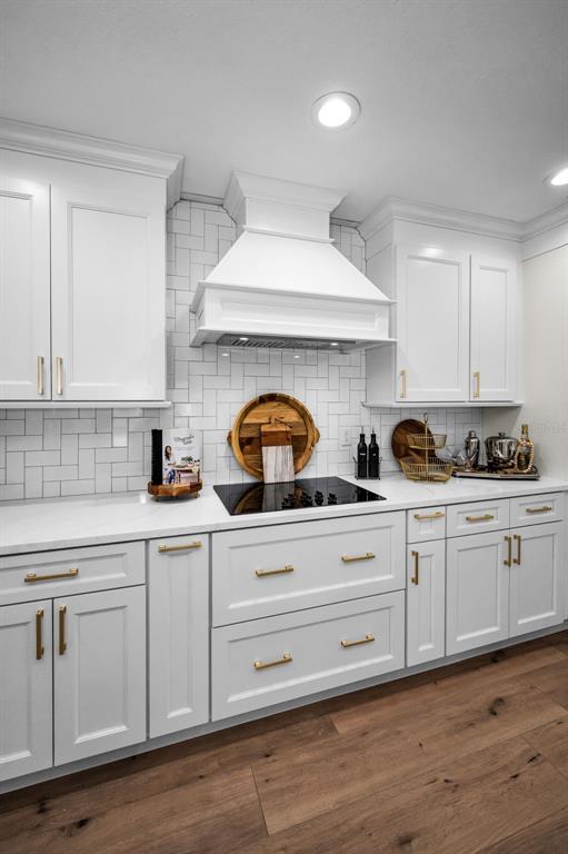 409 Barbara Lane Tampa, FL 33609 - Photo 32 of 51 a kitchen with granite countertop white cabinets and white appliances