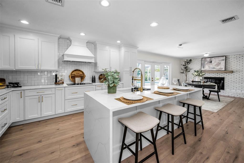 409 Barbara Lane Tampa, FL 33609 - Photo 33 of 51 a kitchen with a table chairs stove and cabinets