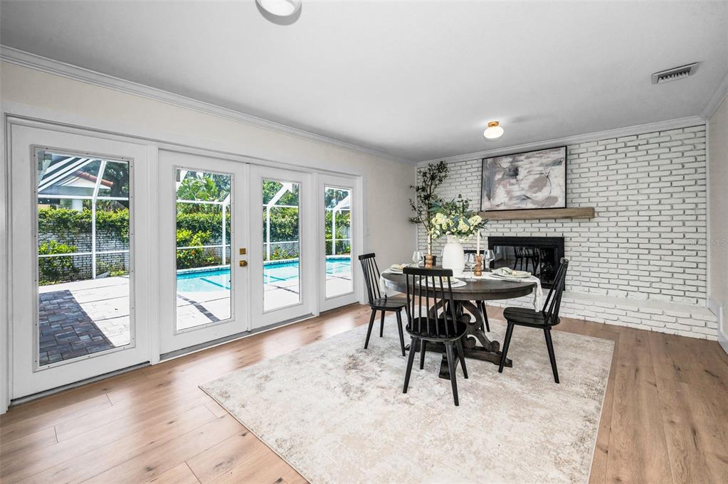 409 Barbara Lane Tampa, FL 33609 - Photo 34 of 51 a dining room with furniture a fireplace and wooden floor