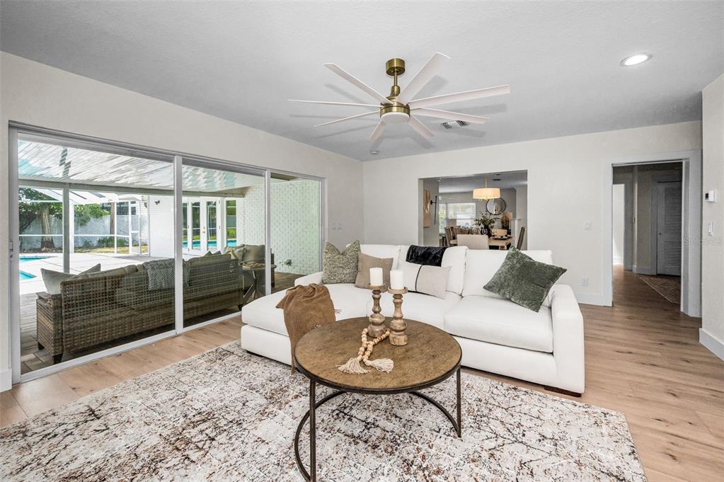 409 Barbara Lane Tampa, FL 33609 - Photo 37 of 51 a living room with furniture a large window and wooden floor