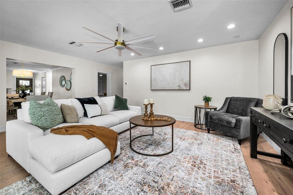 409 Barbara Lane Tampa, FL 33609 - Photo 39 of 51 a living room with furniture a rug and a chandelier