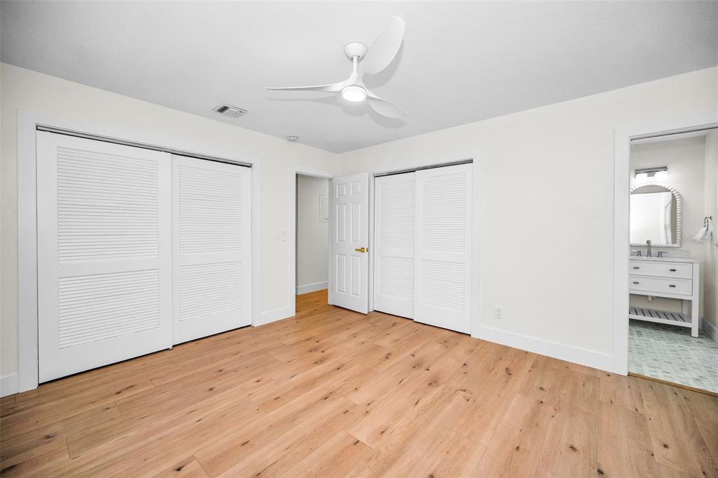 409 Barbara Lane Tampa, FL 33609 - Photo 42 of 51 an empty room with wooden floor and bathroom